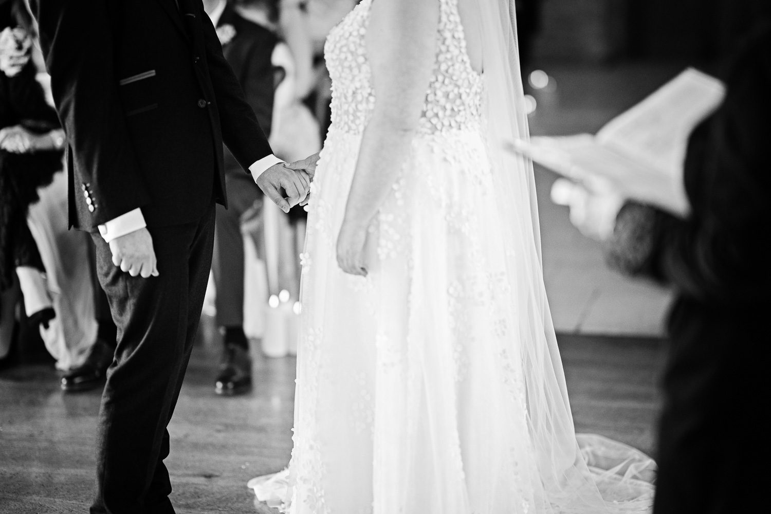 Bride and groom holding hands during their wedding ceremony